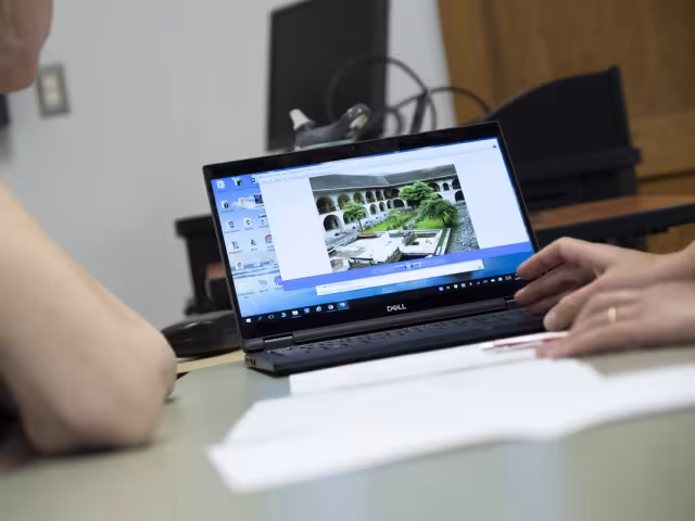Student and instructor work with design software.