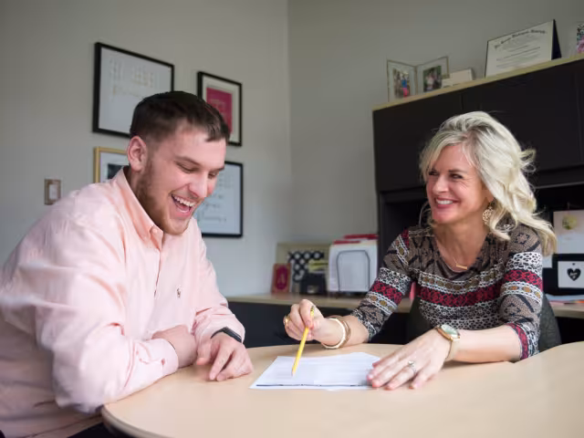 Admissions specialist helps student select classes.
