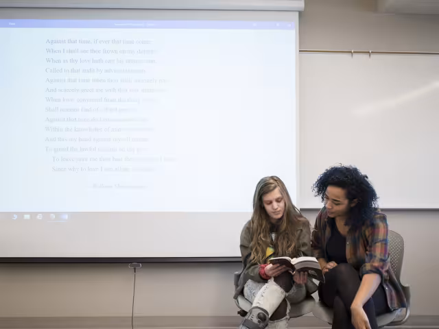 Students reading together in front of their class.