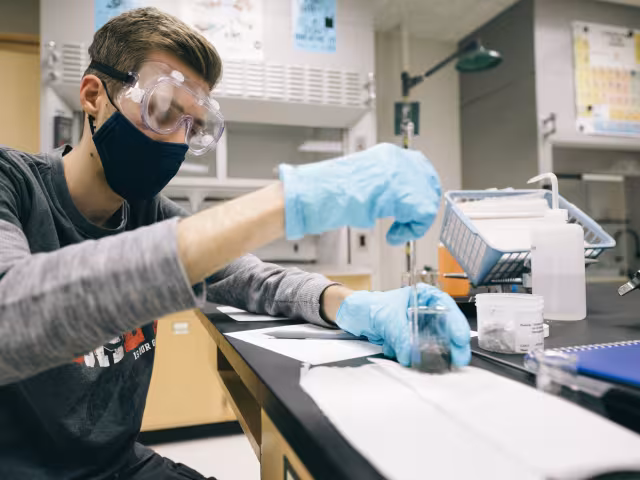 Student using a dropper in a biology lab class