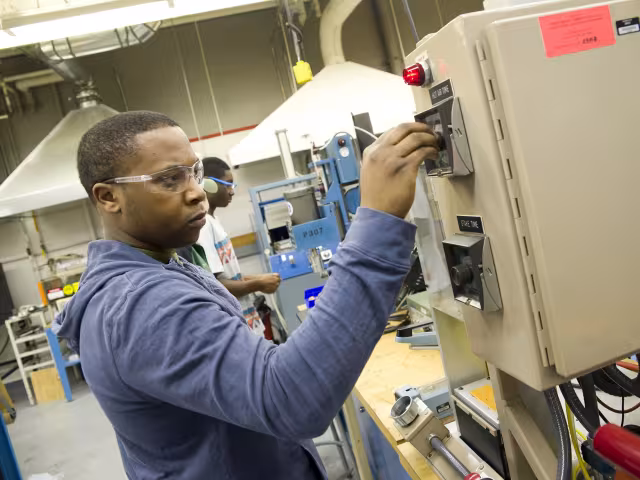 Student working on a plastics machine