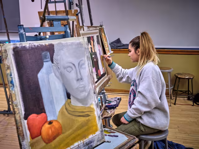 GRCC student in an art class painting