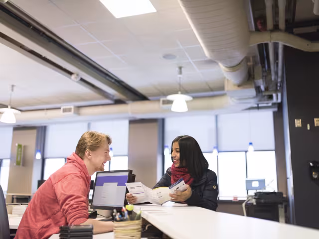 A student gets help enrolling for classes in the Enrollment Center.