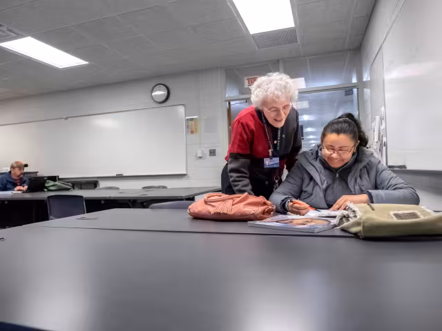 Tutor teaches adult student English as a Second Language.