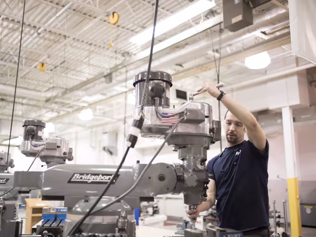 Student operates machinery.