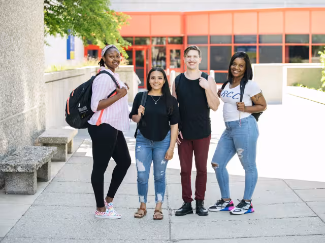 A student group looking confidently into the camera.