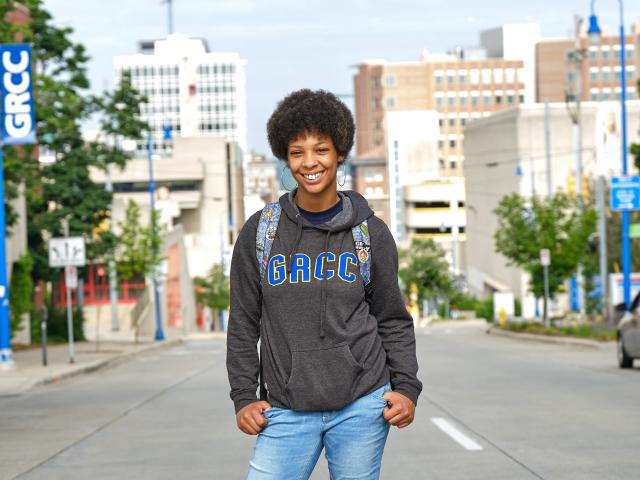 Student standing on Lyon St. with a GRCC sweatshirt.