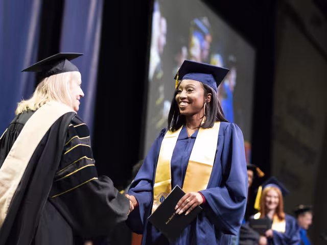 Graduate walking across stage.