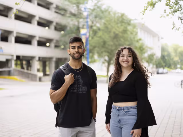 2 guest students outside the parking ramp