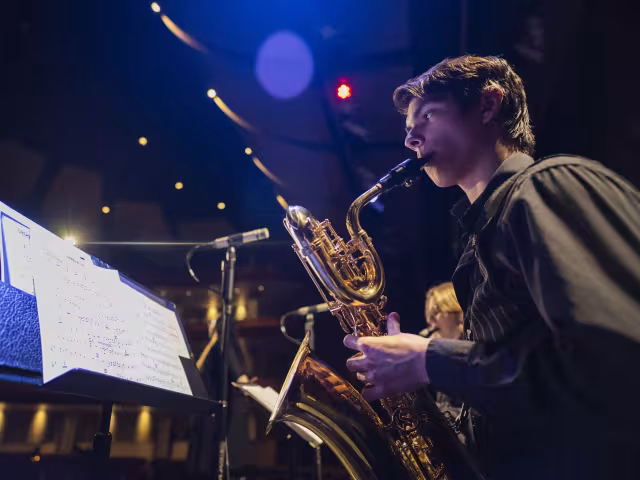 Music Rehearsal with student playing a sax