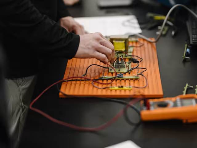 Applied tech student working on wires