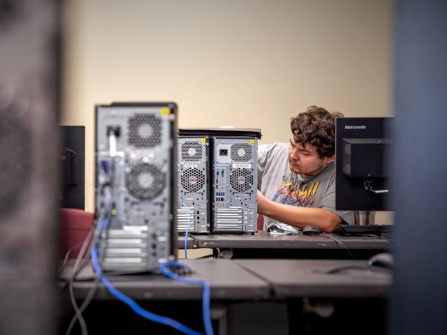 Student working on a computer tower.