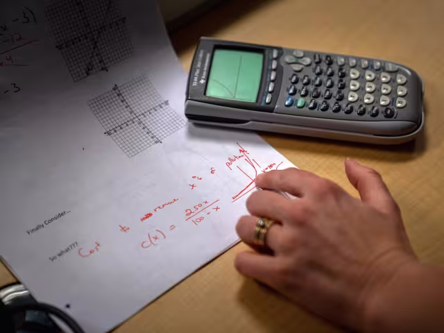 math assignment and calculator on a desk