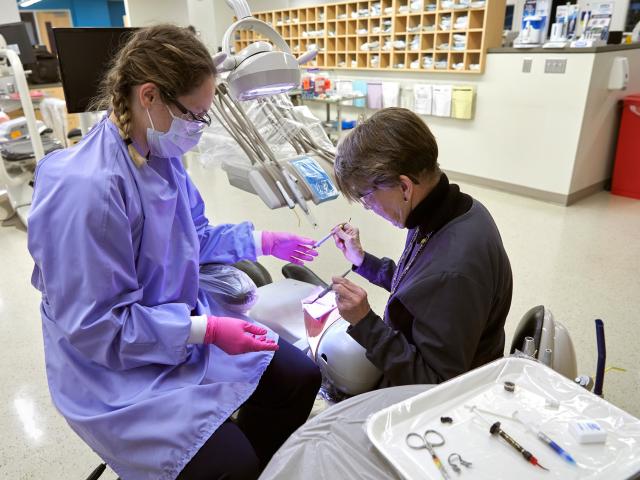 Dental student working with instructor