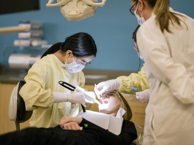 Dental student working on a patient
