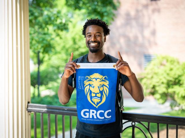 Student holding the GRCC Lion flag