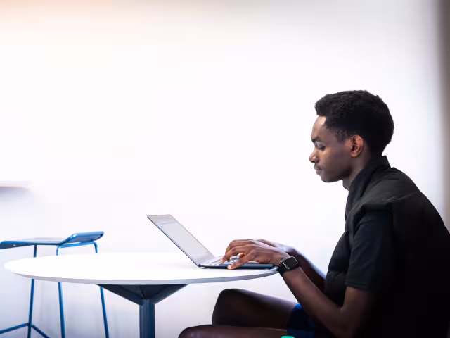 A person sits a laptop.