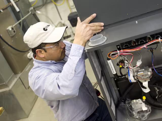 HVAC student working on a furnace