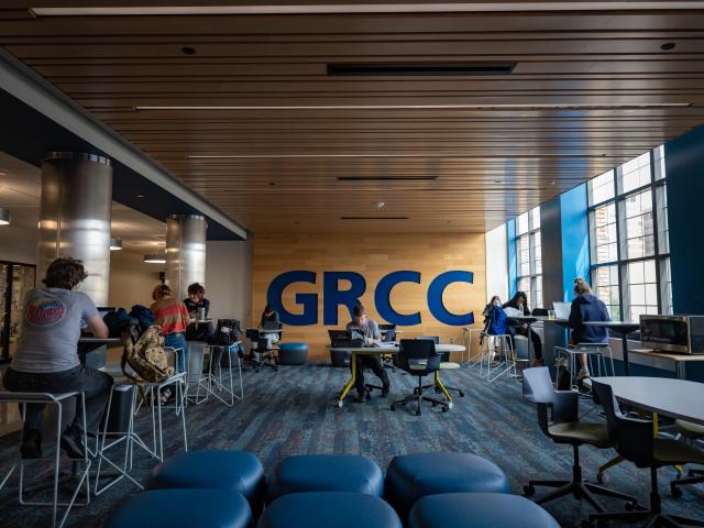 Students sit in a common area and study.