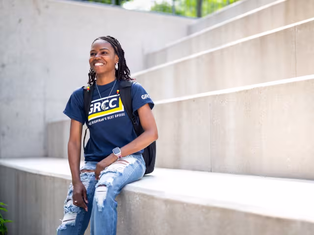 Student sitting outside the library