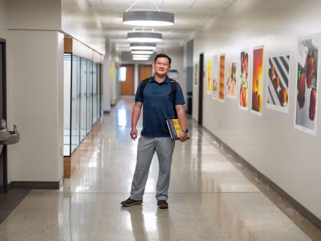 Student in the hallway in RJF 4th floor