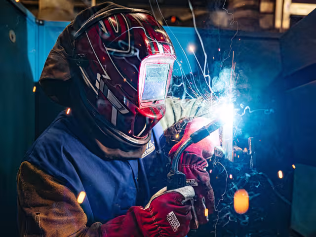Welding student using a torch