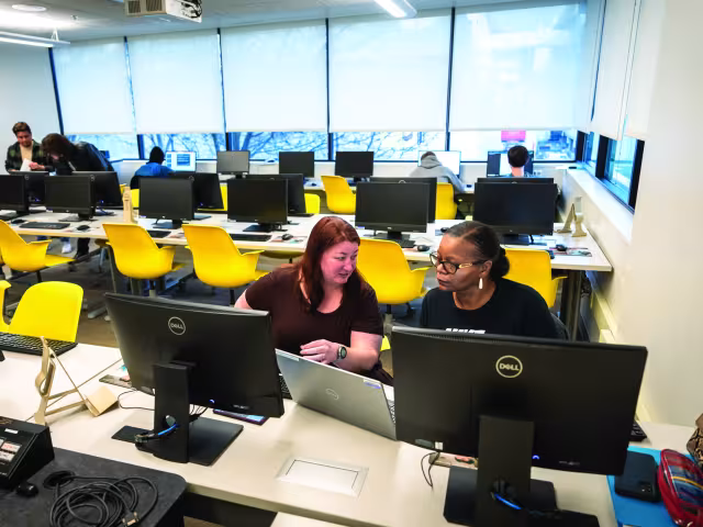 A student and tutor working in the Business Tutorial Center