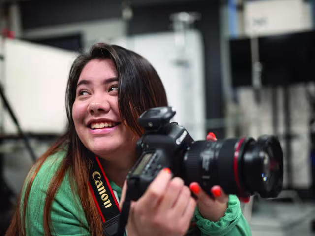 Student holding a camera